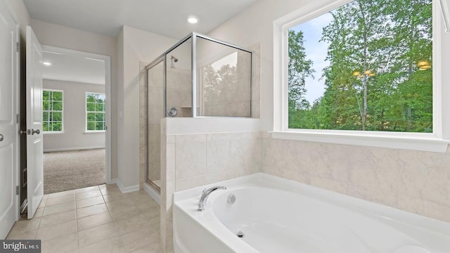 bathroom with plenty of natural light, tile patterned flooring, and shower with separate bathtub