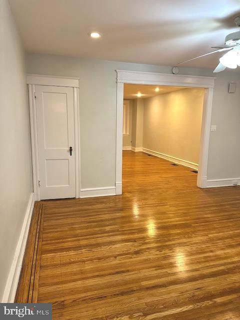 empty room with wood-type flooring and ceiling fan