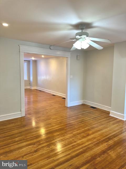 empty room featuring hardwood / wood-style flooring and ceiling fan