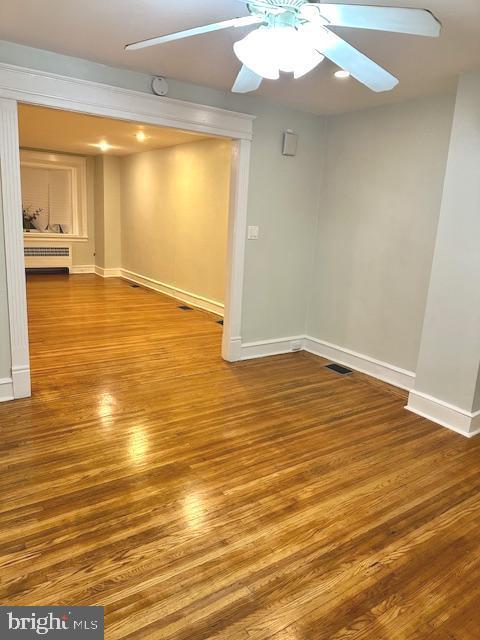 spare room with ceiling fan and wood-type flooring