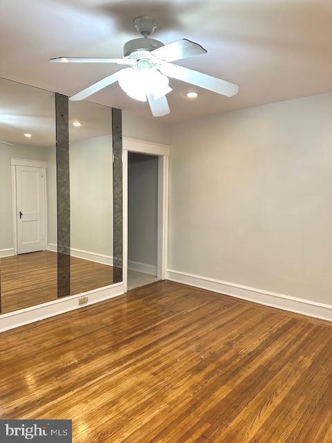 empty room featuring wood-type flooring and ceiling fan