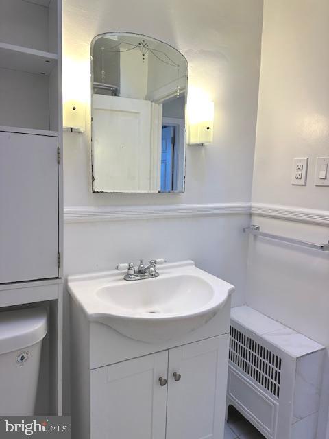 bathroom featuring vanity and toilet