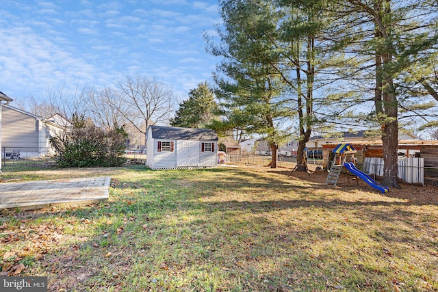 view of yard featuring a storage shed and a playground