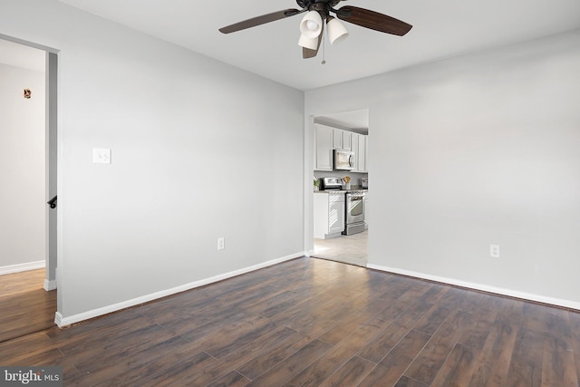 empty room with hardwood / wood-style flooring and ceiling fan