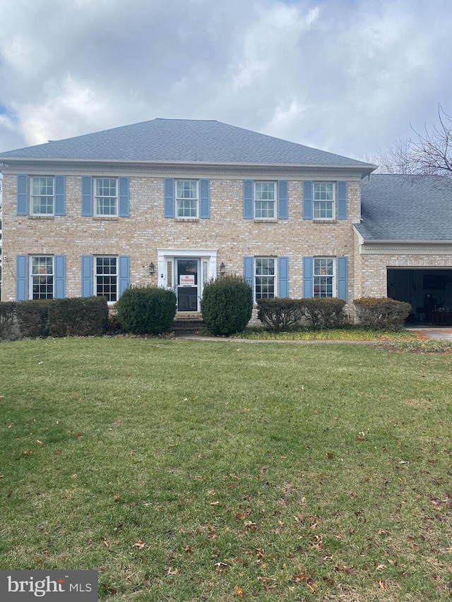 colonial home with a front lawn