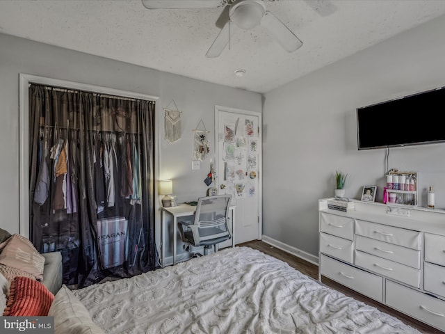 bedroom featuring wood-type flooring, a closet, and ceiling fan