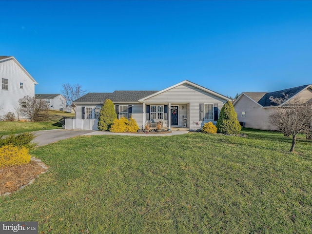 ranch-style home with covered porch and a front yard