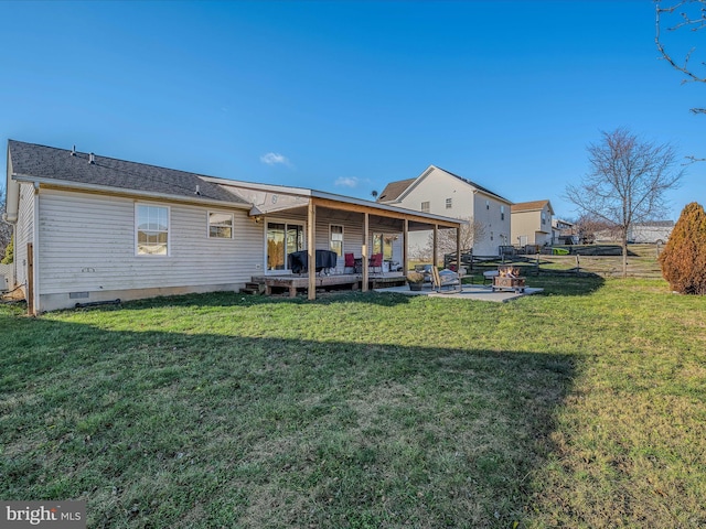 back of property with a yard and a patio