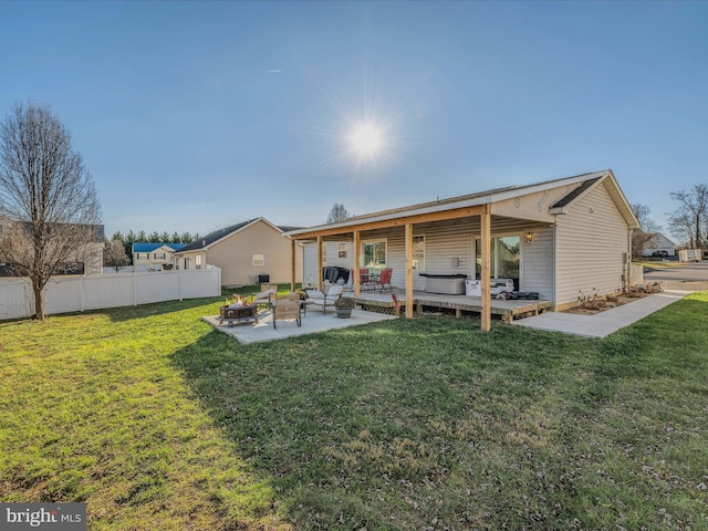 rear view of house featuring a patio area, an outdoor living space, and a yard