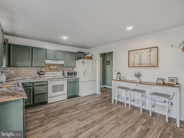 kitchen featuring green cabinets, decorative backsplash, light hardwood / wood-style floors, and white appliances