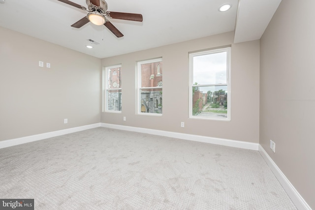 carpeted empty room featuring ceiling fan