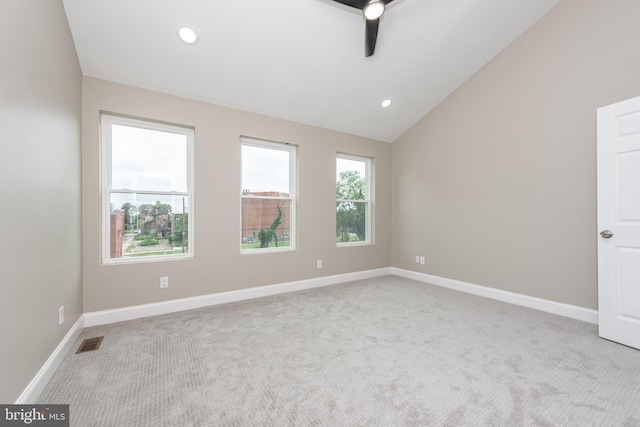 carpeted spare room with ceiling fan and lofted ceiling