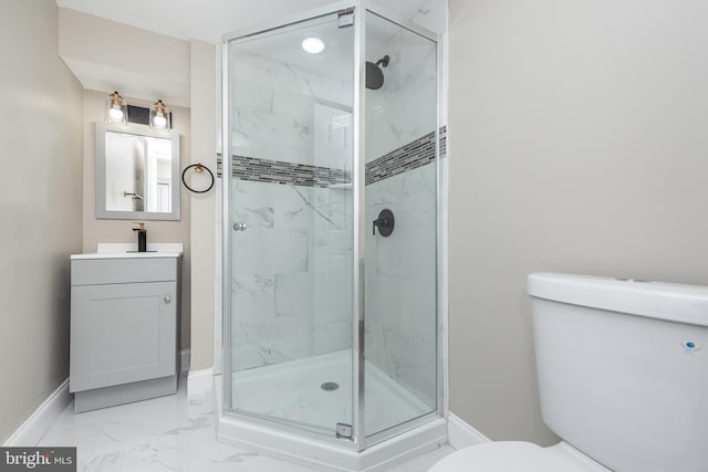 bathroom featuring vanity, toilet, and an enclosed shower