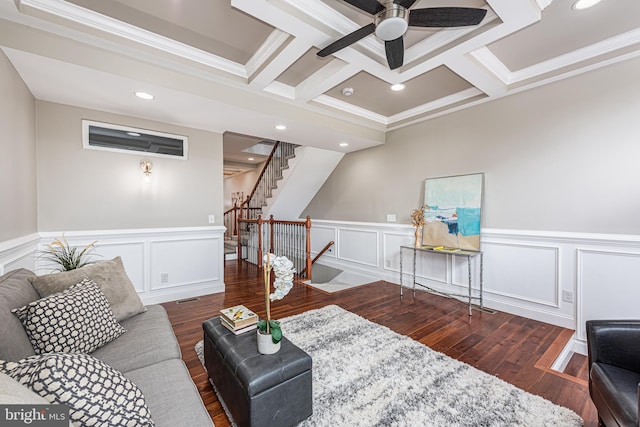 living room featuring crown molding, ceiling fan, dark wood-type flooring, and coffered ceiling