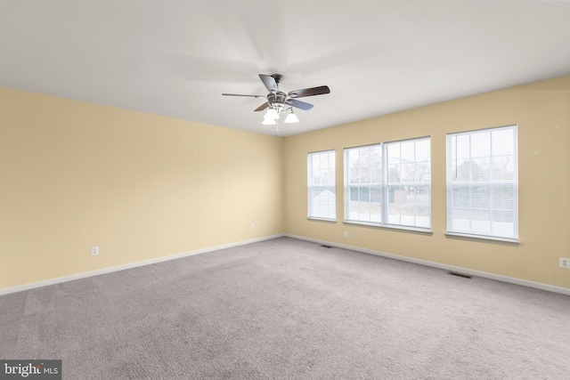 spare room with ceiling fan and carpet floors