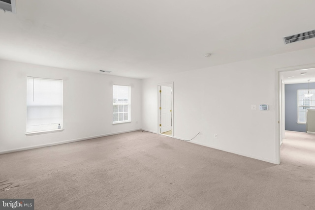 carpeted empty room with plenty of natural light