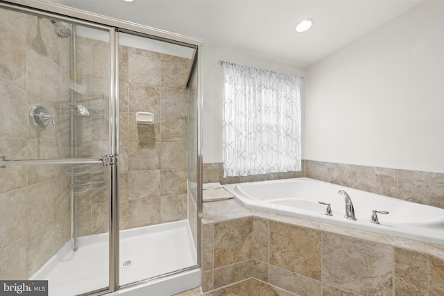 bathroom with shower with separate bathtub