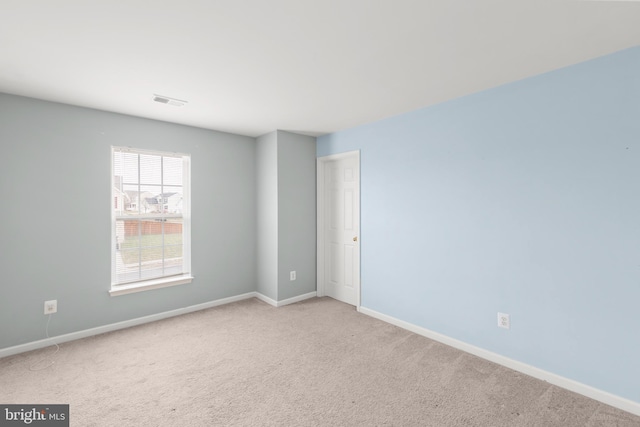 unfurnished room with light carpet