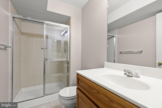 bathroom with vanity, toilet, and an enclosed shower