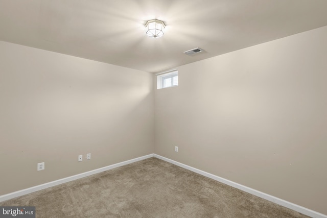 spare room featuring light colored carpet