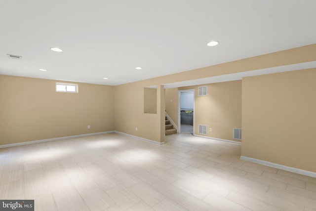 basement with light hardwood / wood-style flooring