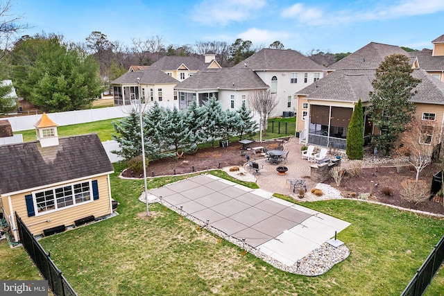 back of house featuring a lawn and a patio area