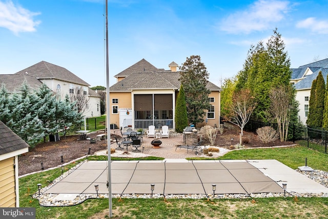 back of house featuring a lawn and a patio