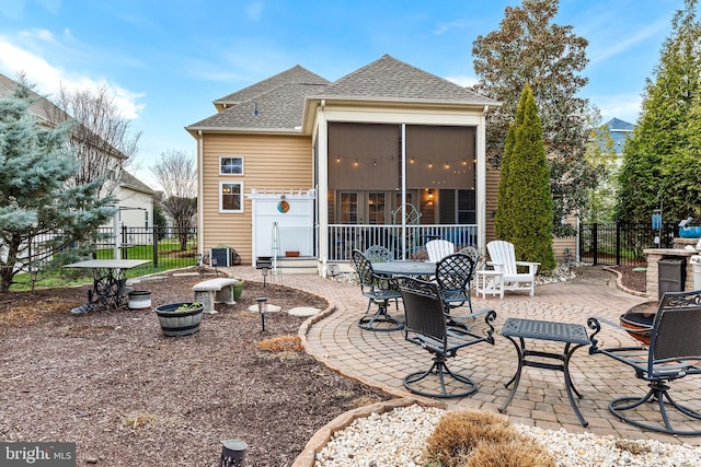 rear view of house with a patio and a sunroom