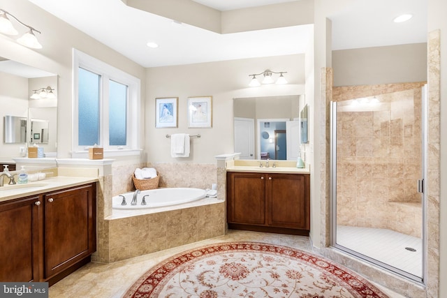 bathroom featuring vanity and plus walk in shower