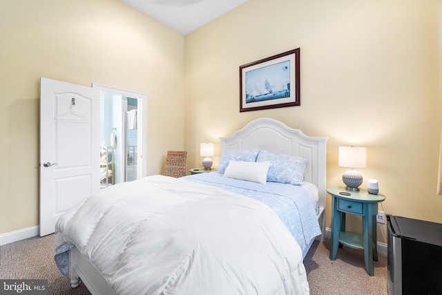 bedroom featuring carpet flooring and vaulted ceiling