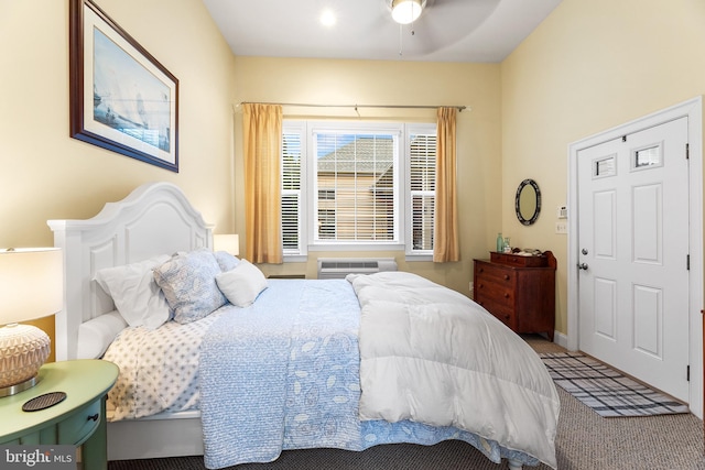 bedroom with ceiling fan, carpet floors, and a wall mounted AC