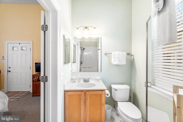 bathroom with vanity, toilet, and a shower