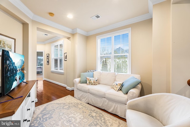 living room featuring dark hardwood / wood-style flooring and ornamental molding