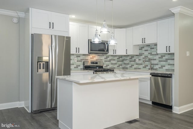 kitchen with a center island, stainless steel appliances, white cabinetry, and sink