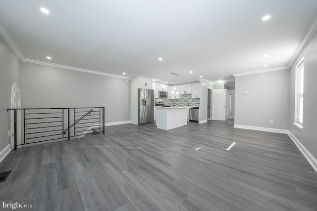 unfurnished living room featuring hardwood / wood-style floors and ornamental molding