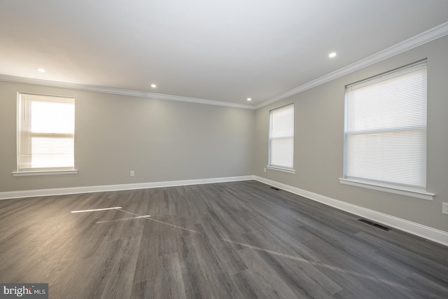 empty room with crown molding and dark hardwood / wood-style floors