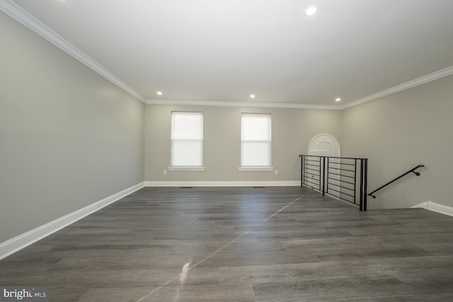 spare room featuring crown molding and dark wood-type flooring