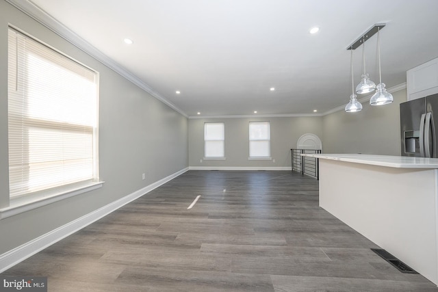 unfurnished living room with crown molding and dark wood-type flooring