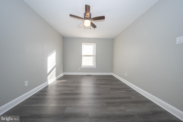 spare room featuring ceiling fan and dark hardwood / wood-style flooring