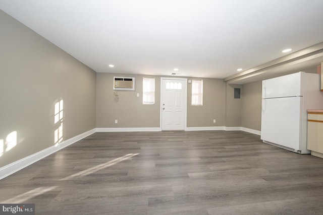 entryway with hardwood / wood-style flooring and a wall unit AC