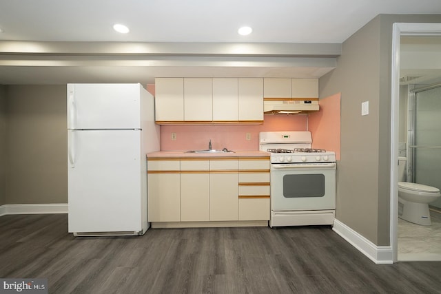 kitchen featuring cream cabinets, white appliances, dark hardwood / wood-style floors, and sink