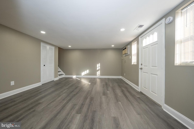 foyer entrance with dark hardwood / wood-style floors and plenty of natural light