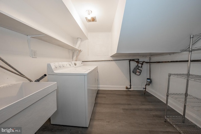 laundry area featuring washer and clothes dryer, dark hardwood / wood-style flooring, and sink