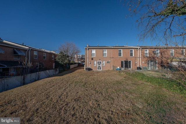 rear view of house with a yard