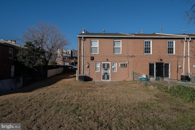 back of house with a lawn and central AC