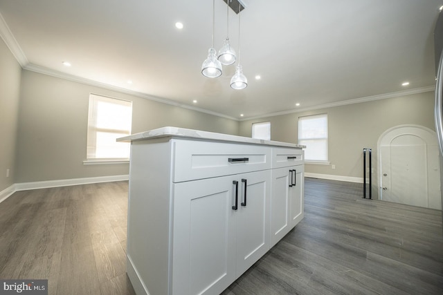 kitchen featuring pendant lighting, crown molding, a kitchen island, dark hardwood / wood-style flooring, and white cabinetry