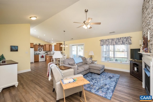 living room featuring ceiling fan, a fireplace, dark wood-type flooring, and lofted ceiling