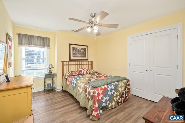 bedroom featuring ceiling fan, wood-type flooring, and a closet