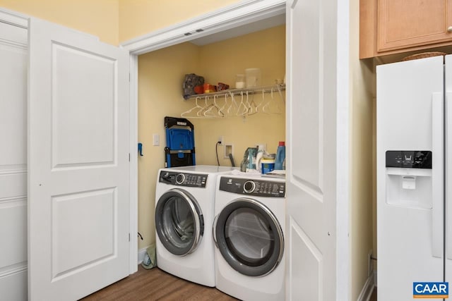 laundry room featuring washing machine and dryer and hardwood / wood-style floors