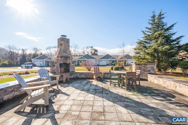 view of patio / terrace featuring an outdoor stone fireplace